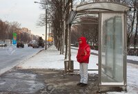 12006648-Man-standing-in-a-bus-shelter-waiting-for-a-bus-Stock-Photo-stop.jpg